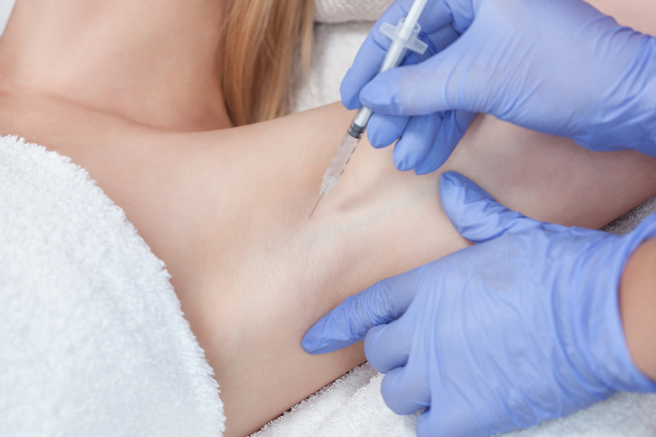 The doctor makes intramuscular injections of botulinum toxin in the underarm area